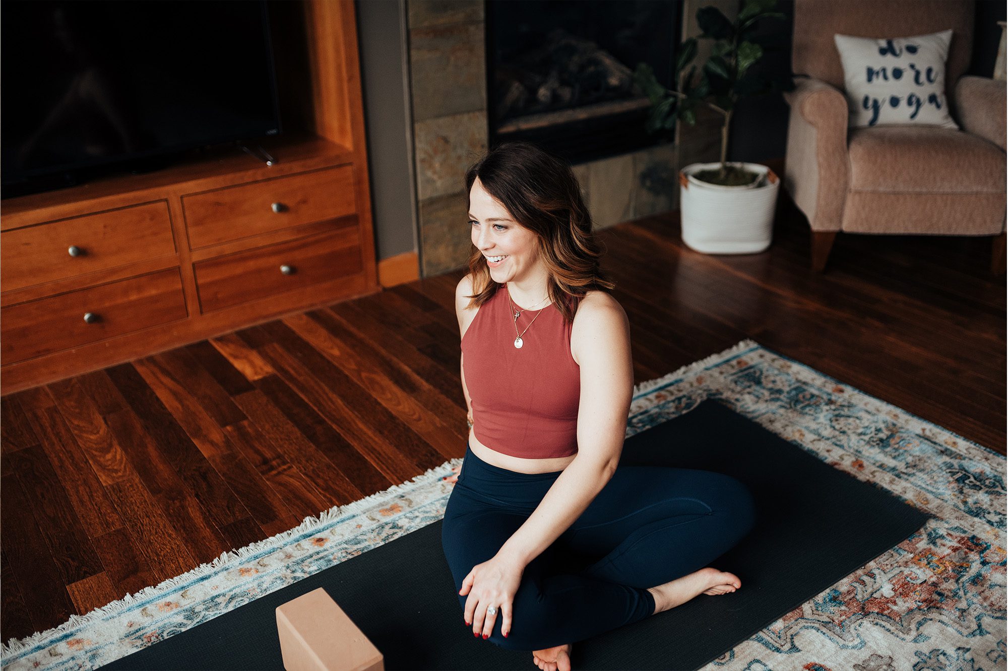 female practicing yoga in living room